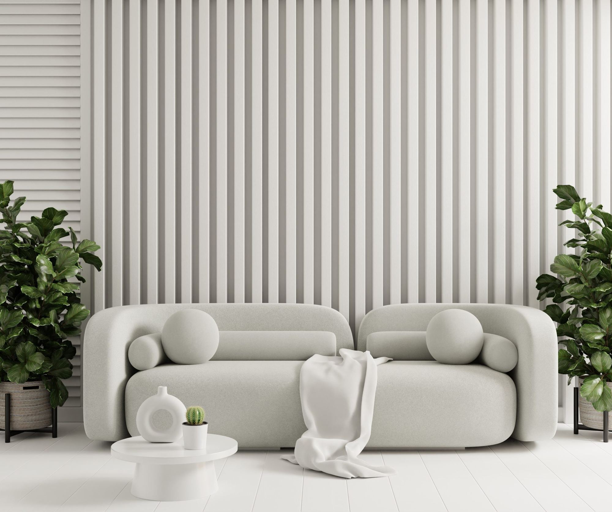 Pale sculpted sofa in front of a ribbed wall